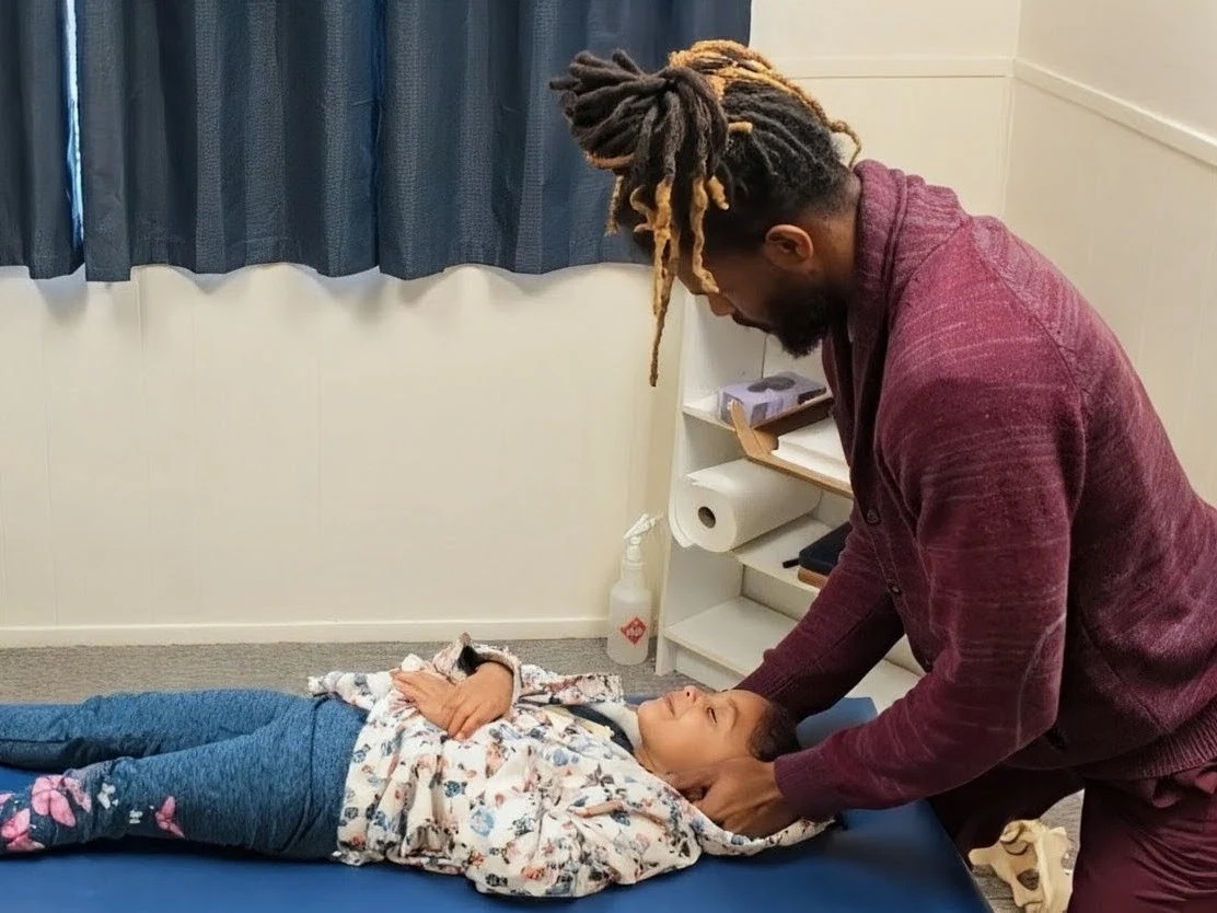 Dr. Kendell Jack performing a pediatric adjustment on a child