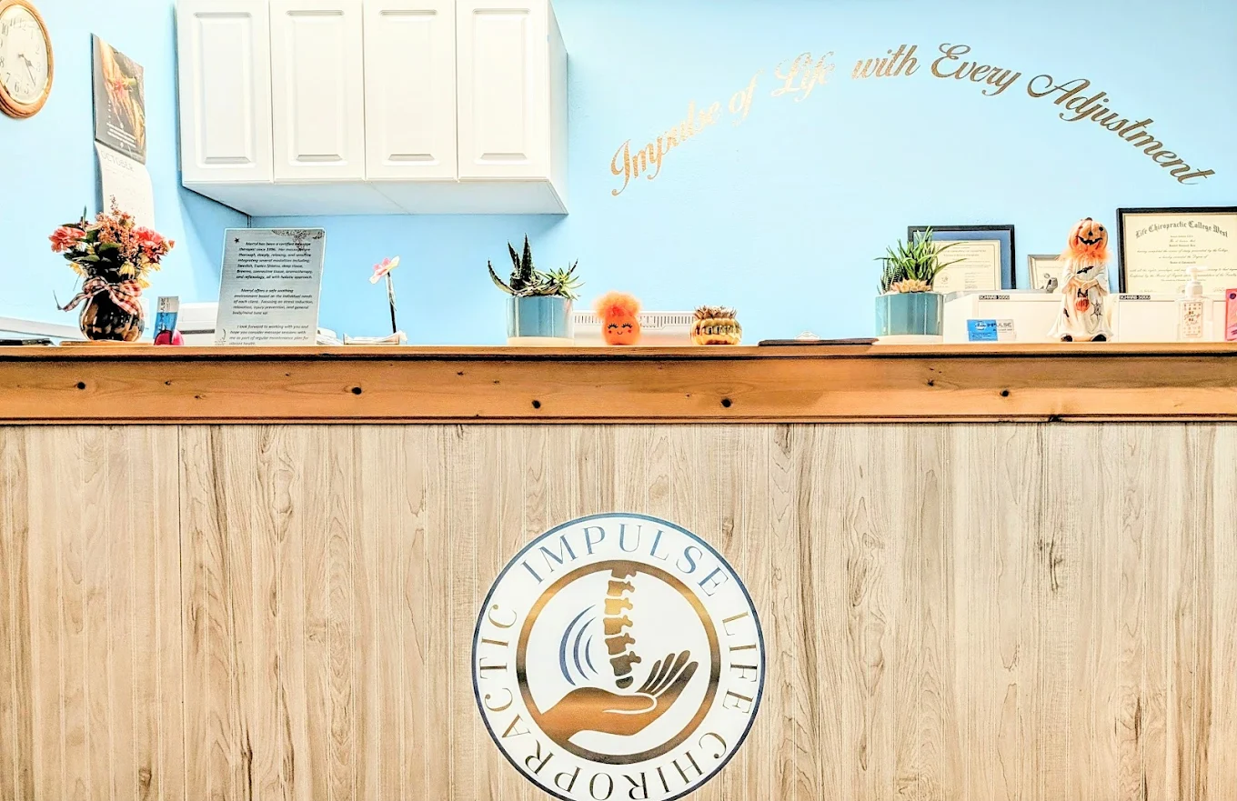 Impulse Life Chiropractic front desk with logo and wall lettering